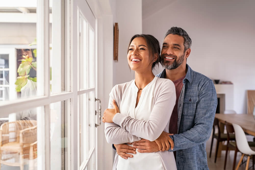 Smiling mid adult couple hugging each other