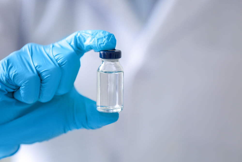 Doctor holding medicine for vaccination, closeup