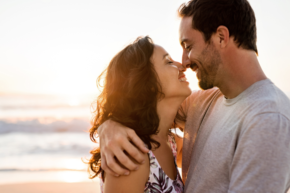 Affectionate Young Couple Standing Close In Each Other's Arms On