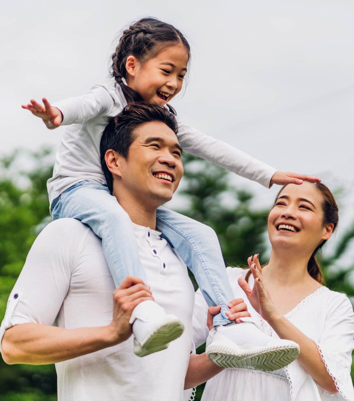 Family father and mother holding cute little girl child smiling