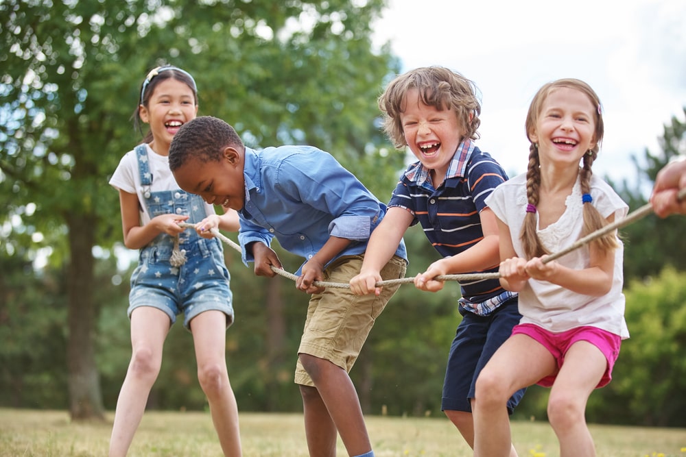 Children playing tug of war at the park