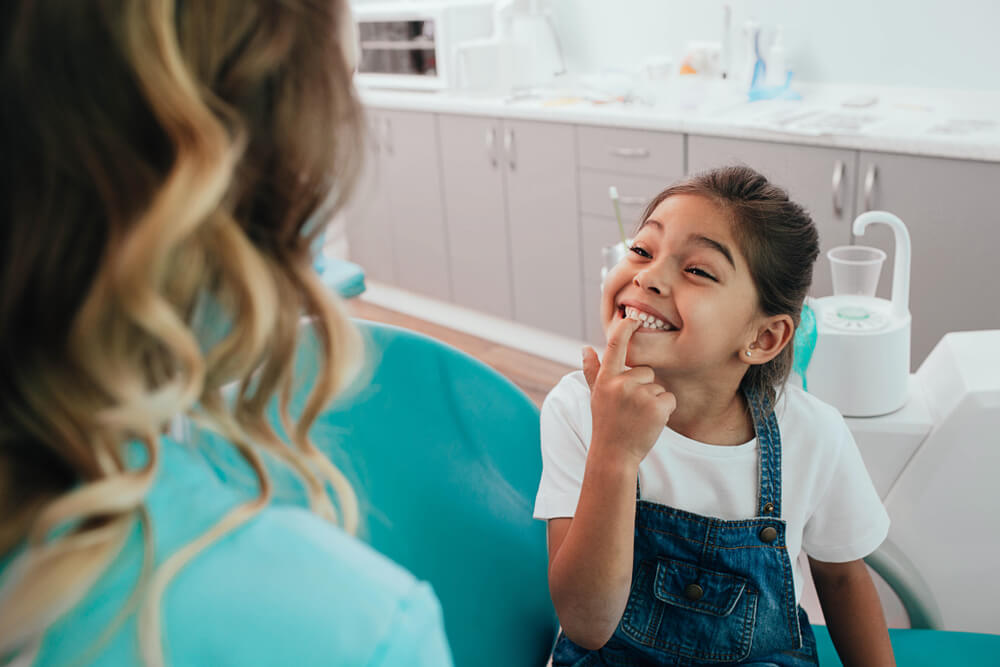 little patient showing her perfect toothy smile