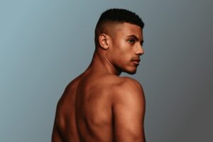 shirtless muscular man looking away