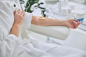 Young female in white bathrobe during medical procedure