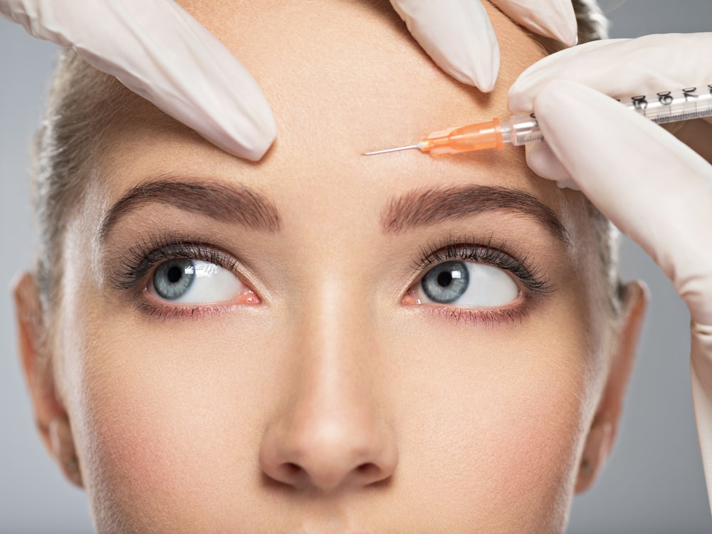 Young woman getting cosmetic injection