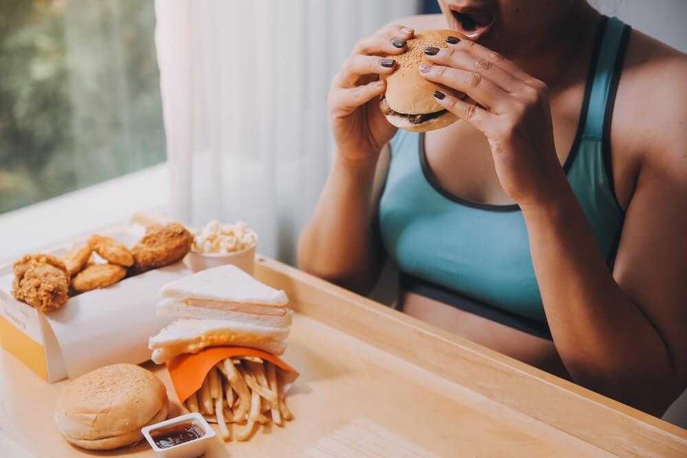 woman eating fast food burger