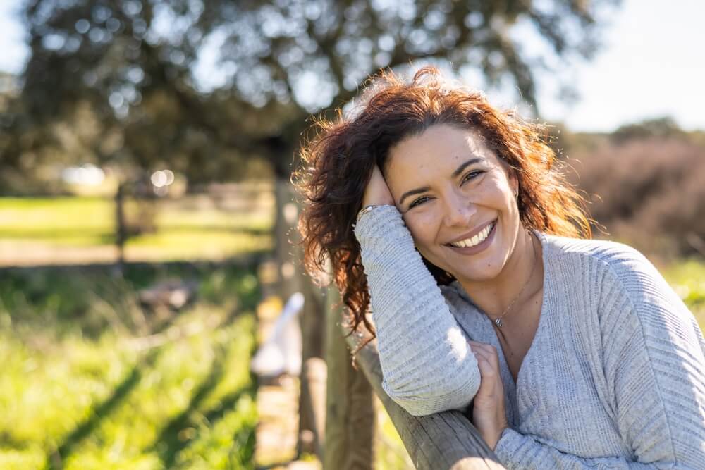 Happy Woman Smiling In A Field