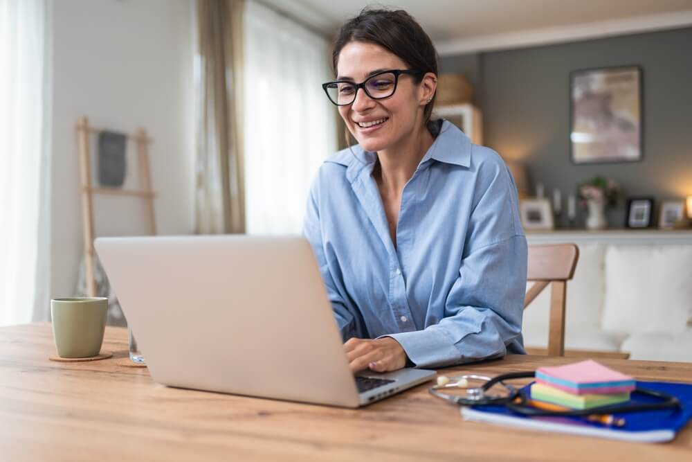 Young woman doctor working at home office