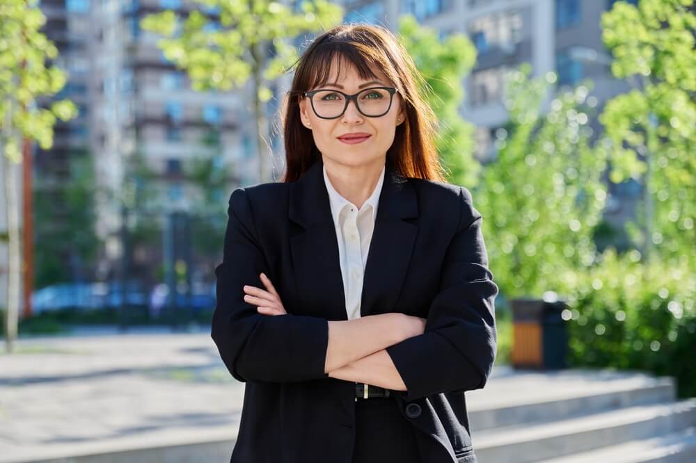 middle-aged confident woman in suit, outdoors