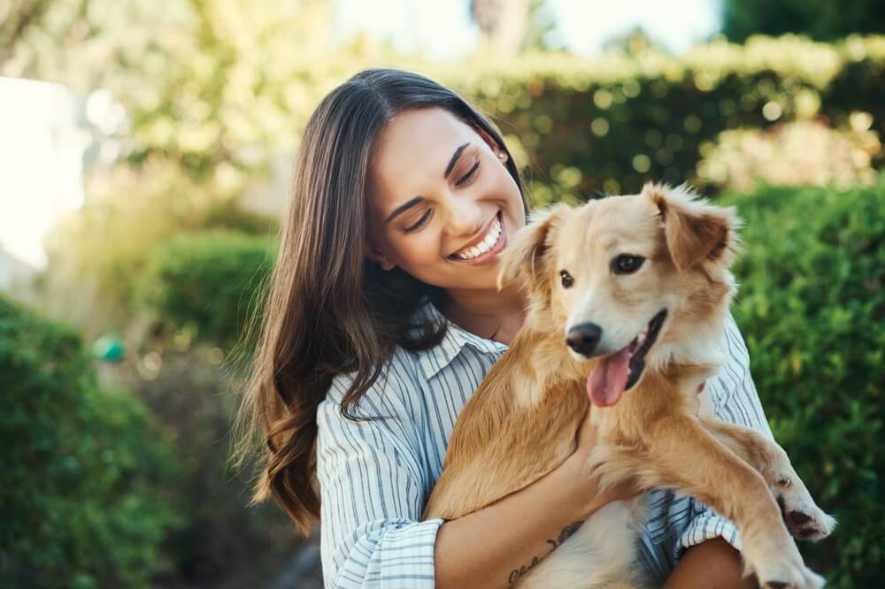 woman and smile for dog hug with bonding time