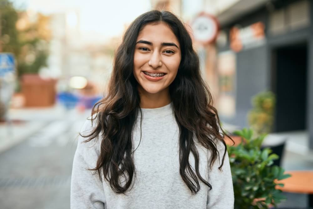 Young girl smiling happy standing at the city