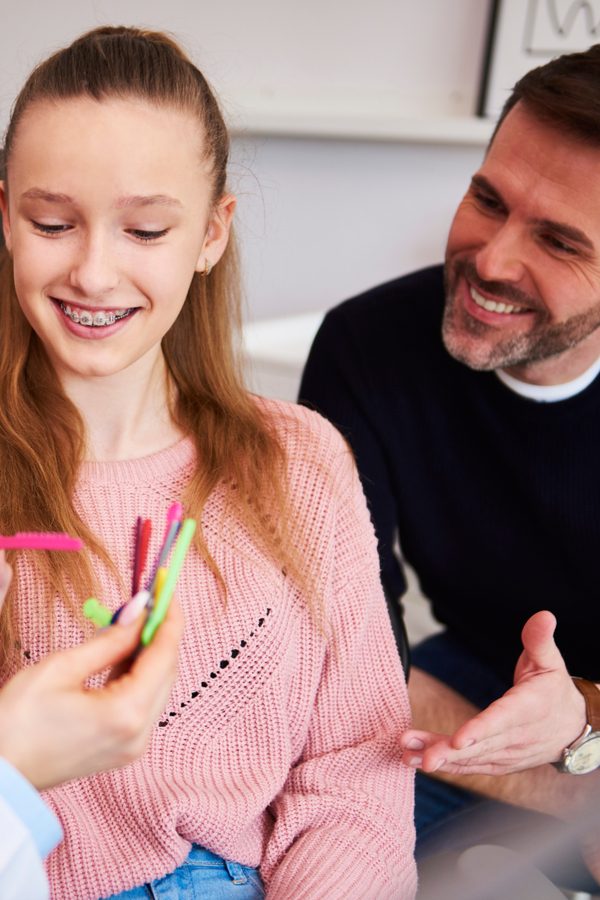 Girl choosing the color of rubber bands for braces