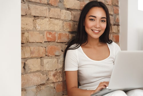 Happy women using laptop