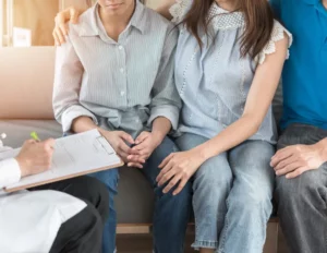 Teenager patient with parents consulting with gynecologist