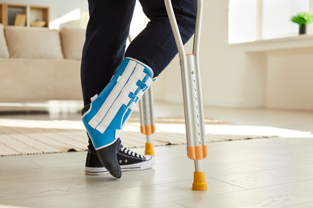 Close Up Leg Of Man Walking With Crutches In Ankle