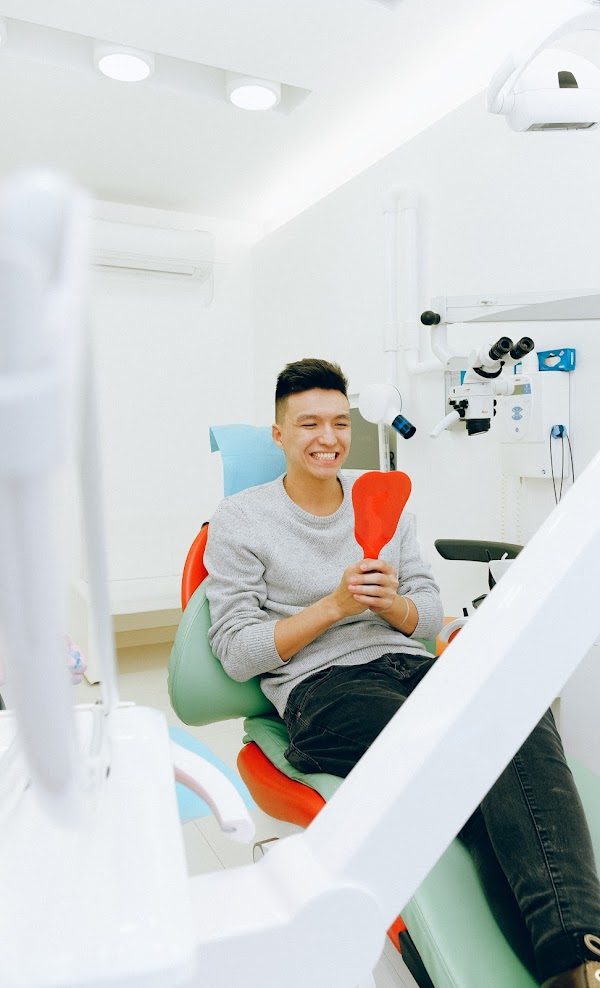 Happy Patient looking teeth in mirror