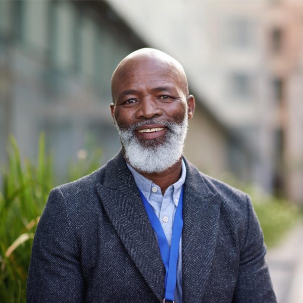 Portrait mature african american businessman smiling happy in city