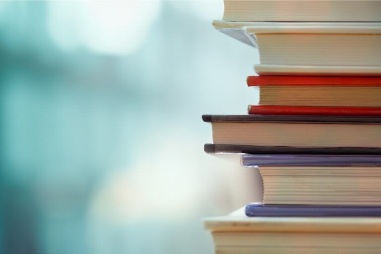 Book stack in the library room and blurred bookshelf for business and education