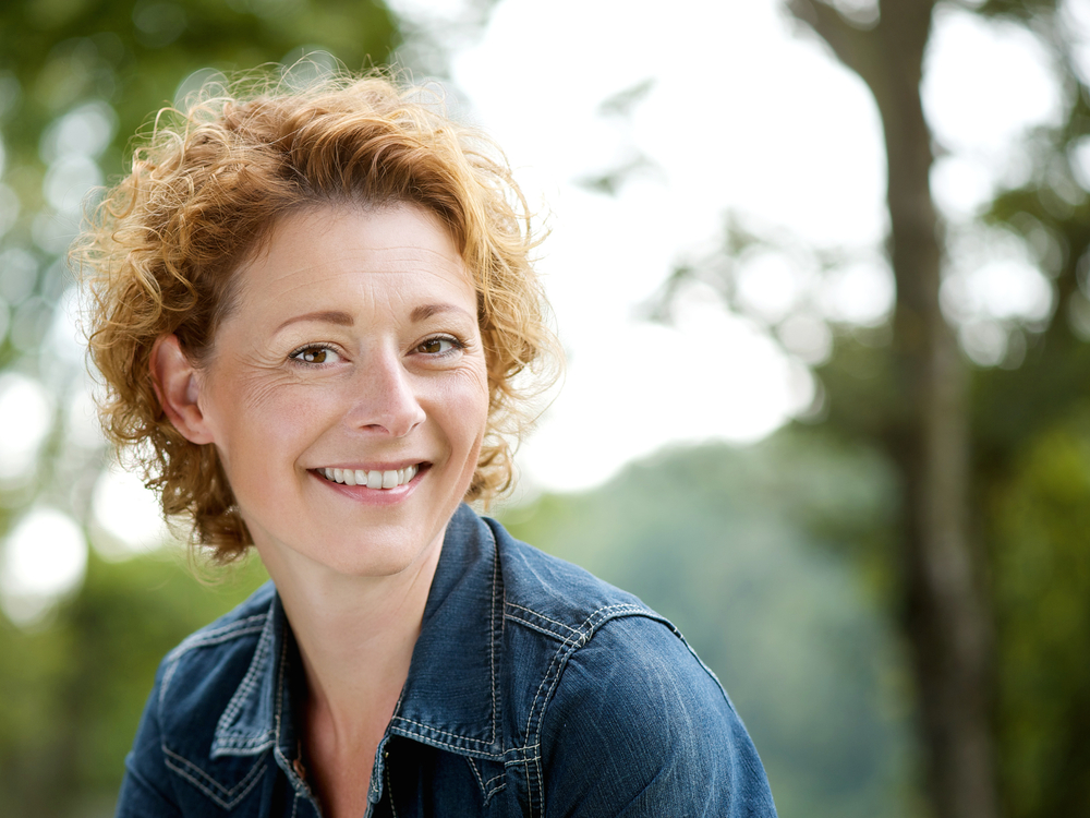 cheerful older woman smiling outdoors