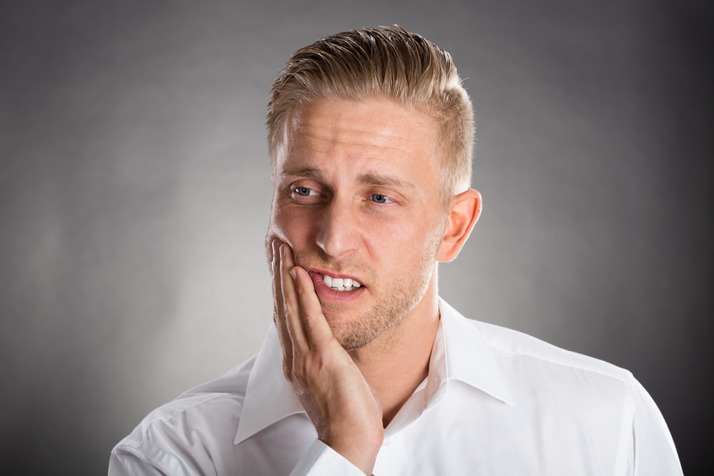 Young Man Suffering From Toothache