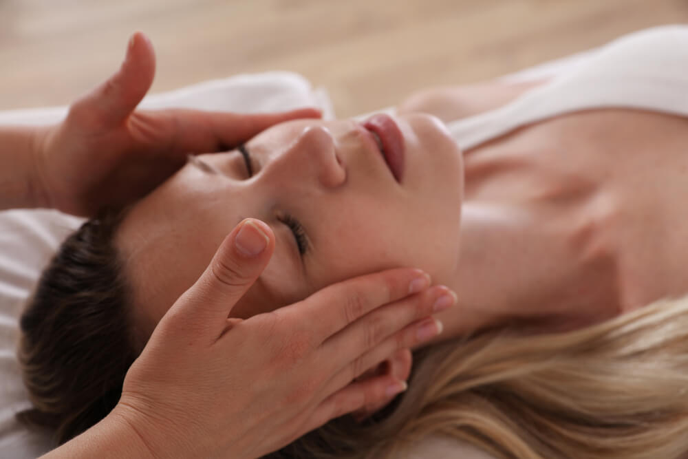 Woman enjoying head massage. Acupressure, reiki healing treatment