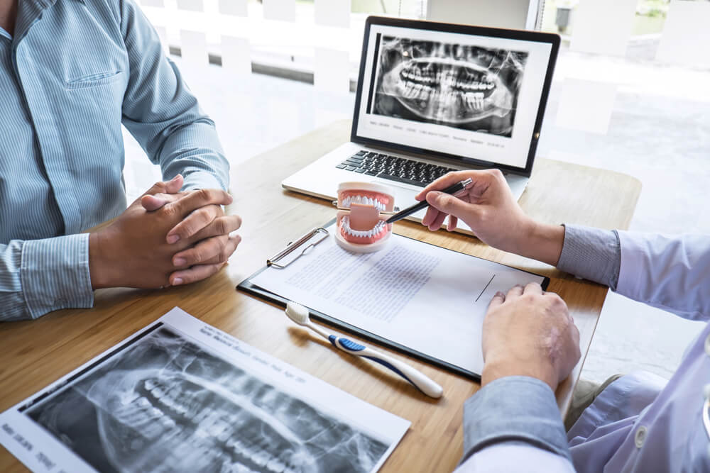 Professional Dentist showing jaw and teeth the x-ray photograph