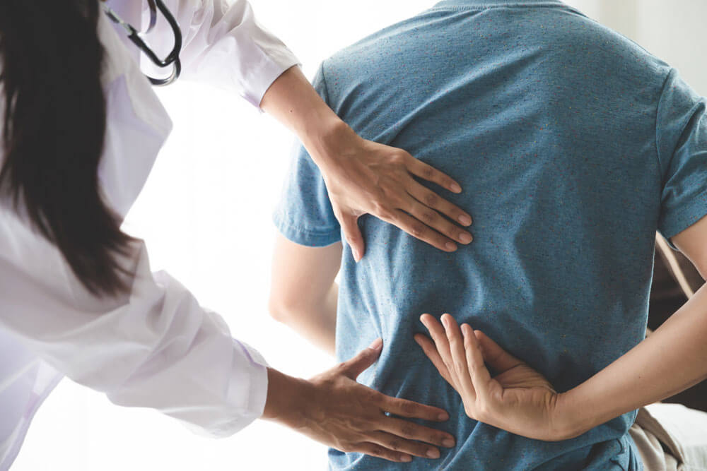 Physiotherapist working with patient in clinic, closeup