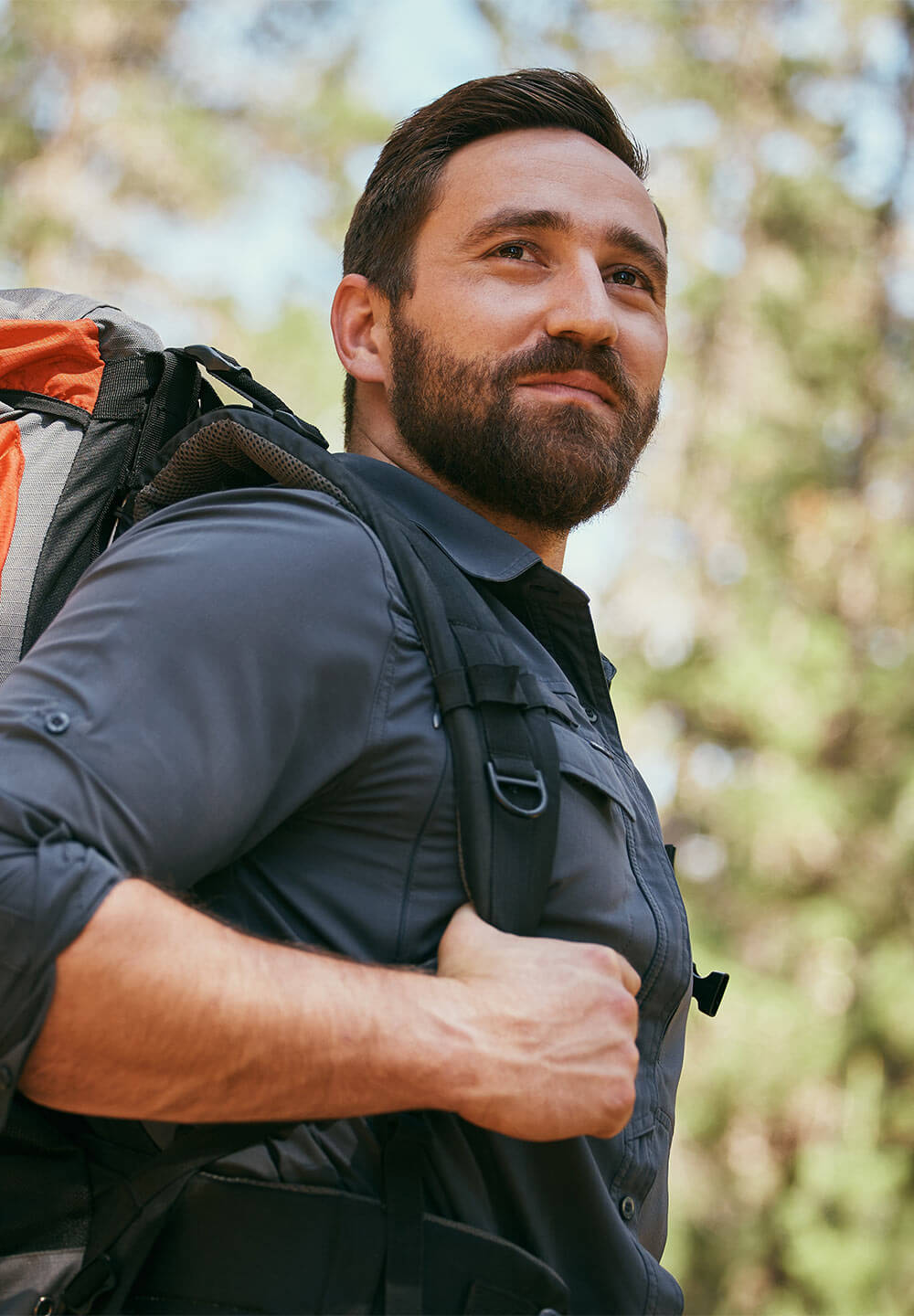 Man with backpack trekking in natur