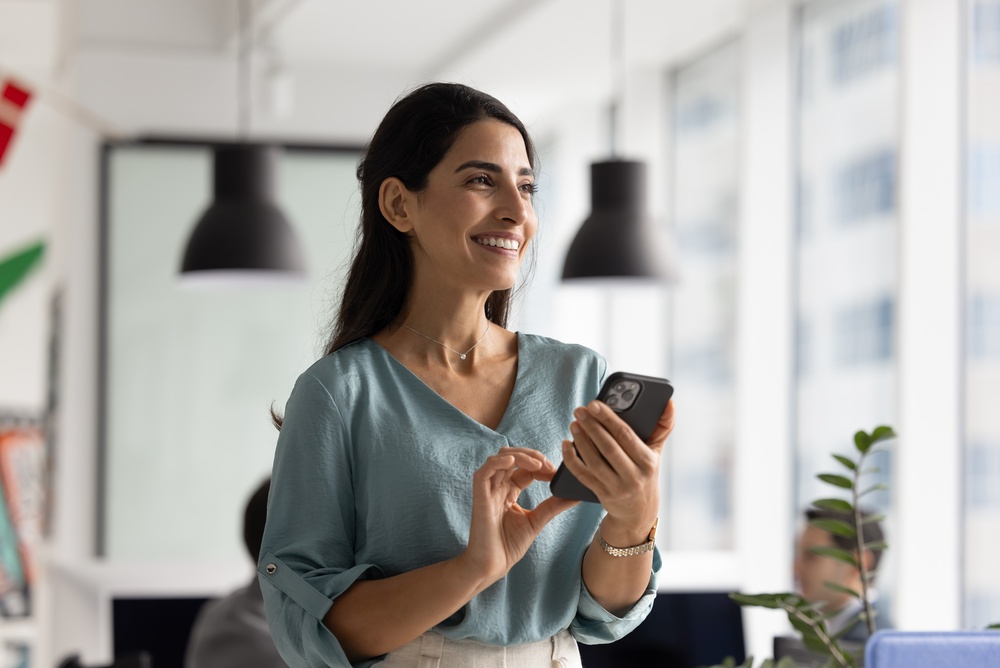 Smiling female professional using mobile phone