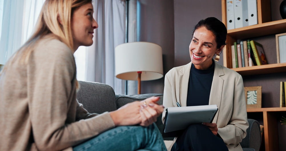Counseling, therapist or woman writing notes for help, mental health or addiction recovery.