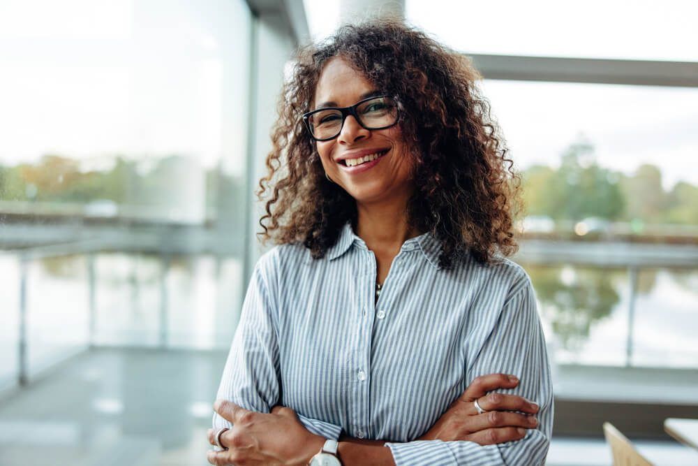 Portrait of female professional with curly hair wearing eyeglasse