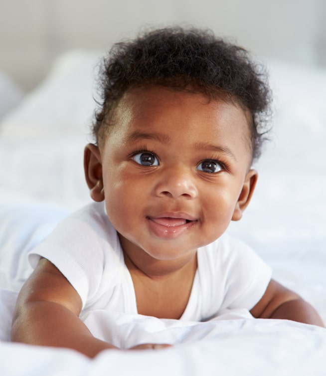 Cute Baby Lying On Tummy In Bed