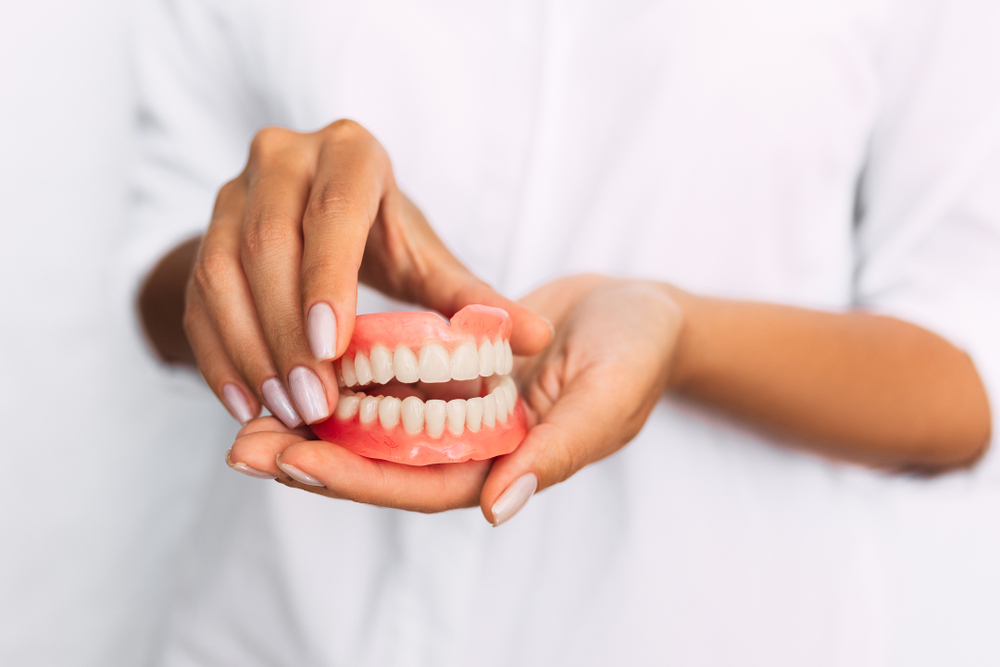 The,Dentist Is Holding Dentures