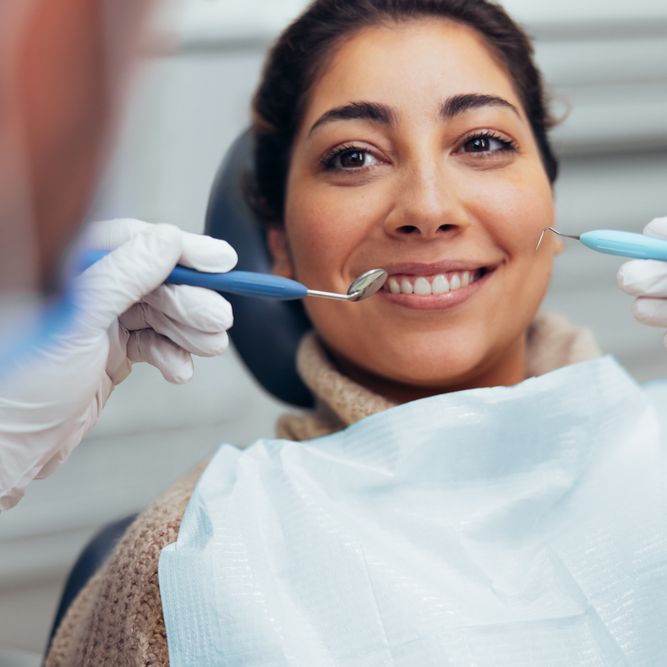 Smiling woman getting her teeth checked