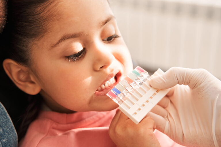 Dentist choosing color of filling from palette concept