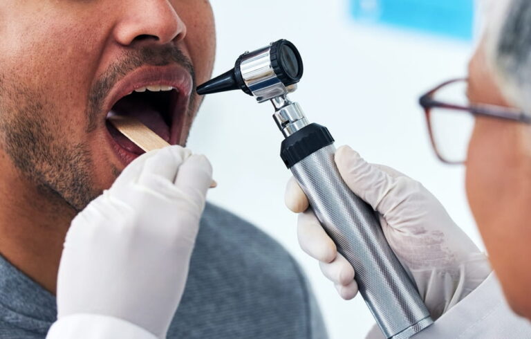 Medical, consulting and doctor with mouth of person and check for cancer, dentist or surgery