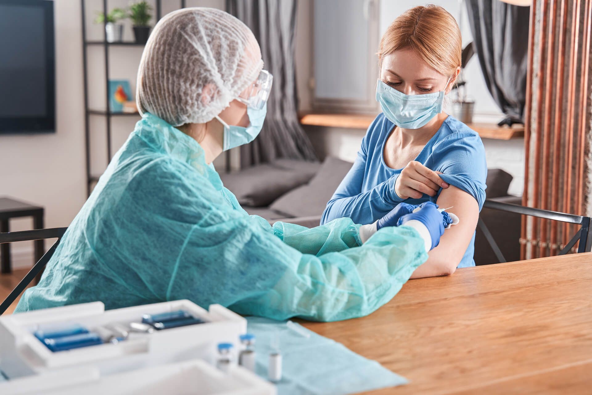 Doctor making vaccination to blonde woman patient