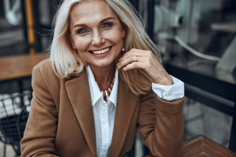 Mature woman outdoors expressing happiness photo