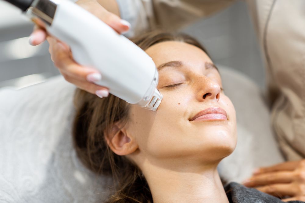A photo of a women receiving a Acne Laser Treatment