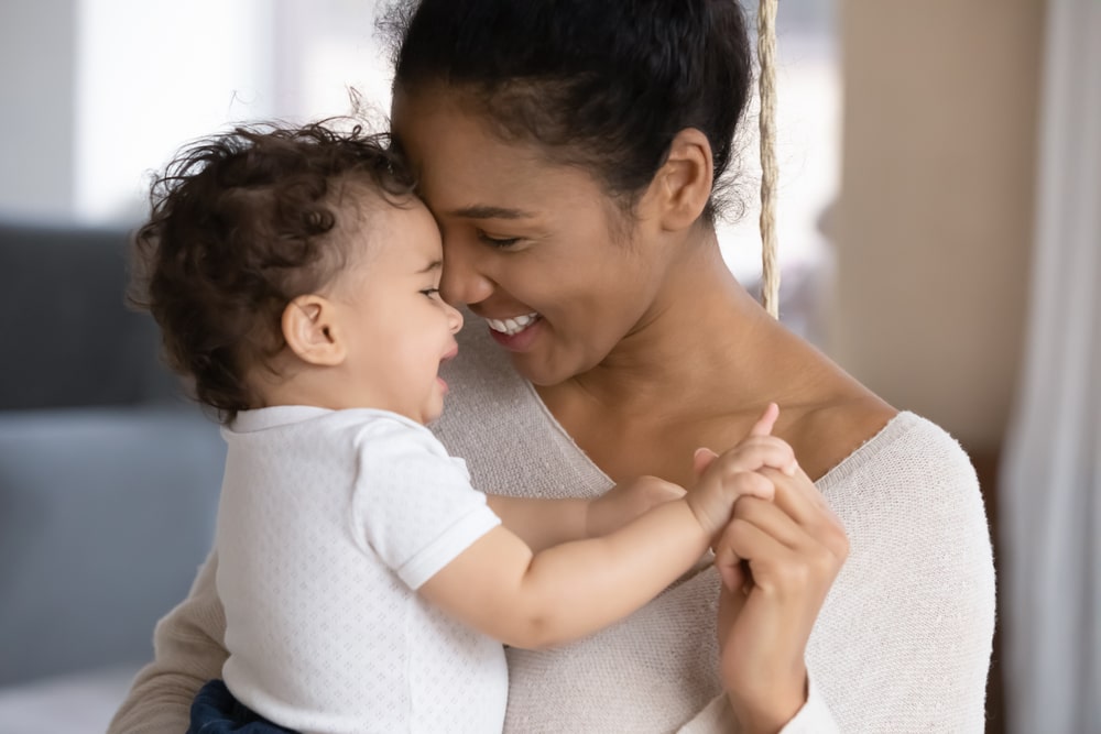 happy young mother hug cuddle little infant