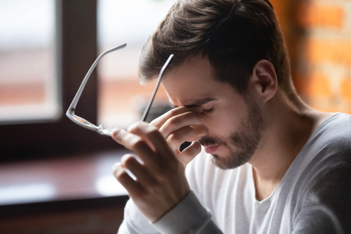 Close up of tired male take off glasses massage eyes