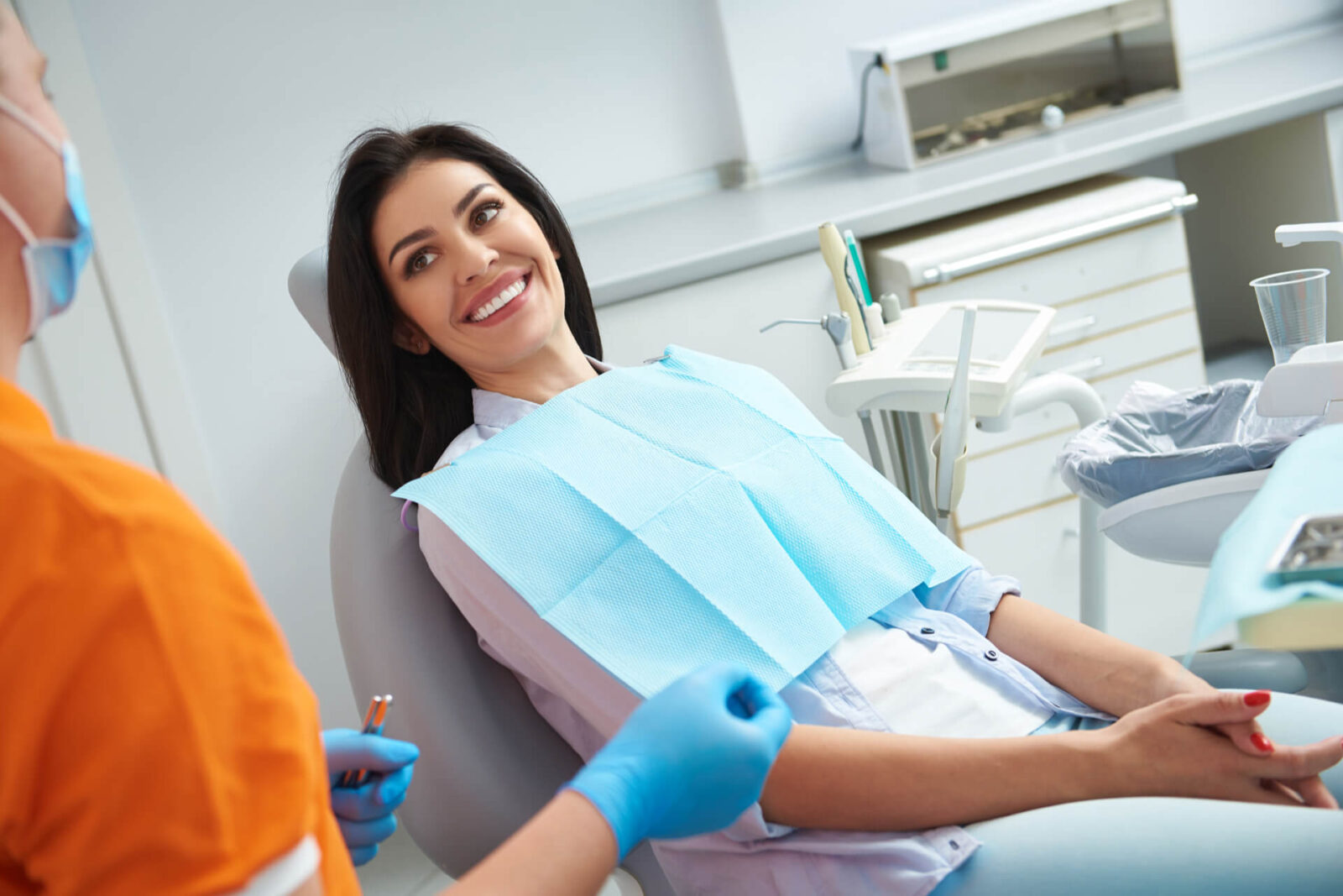 Male stomatologist in sterile gloves holding dental instruments