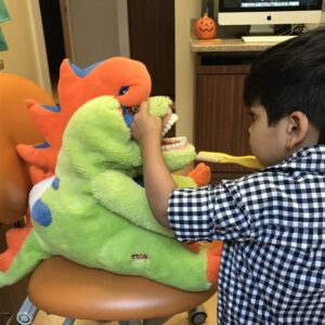 single 8 years old Asian boy playing colorful toy in recreation room