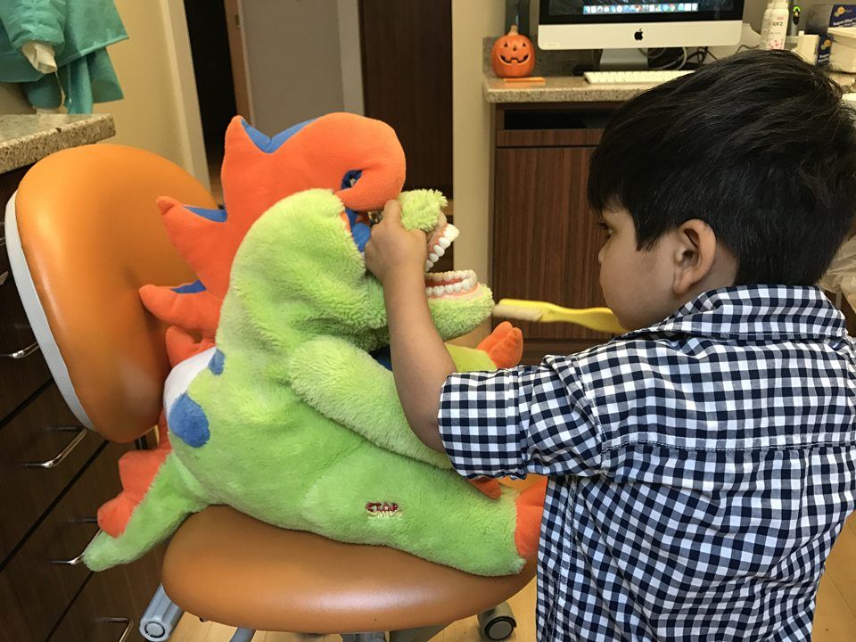 single 8 years old Asian boy playing colorful toy in recreation room