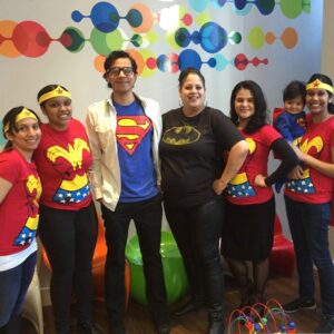 A young family in red and blue suits of superheroes.