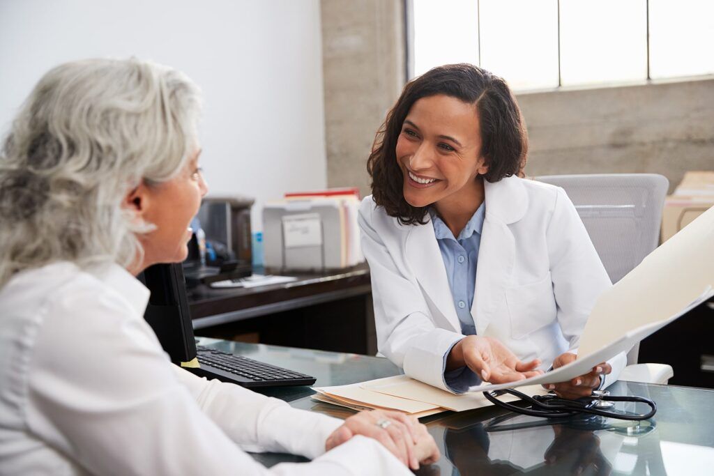 Woman doctor talking to woman patient