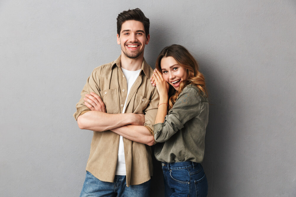 cheerful young couple standing together