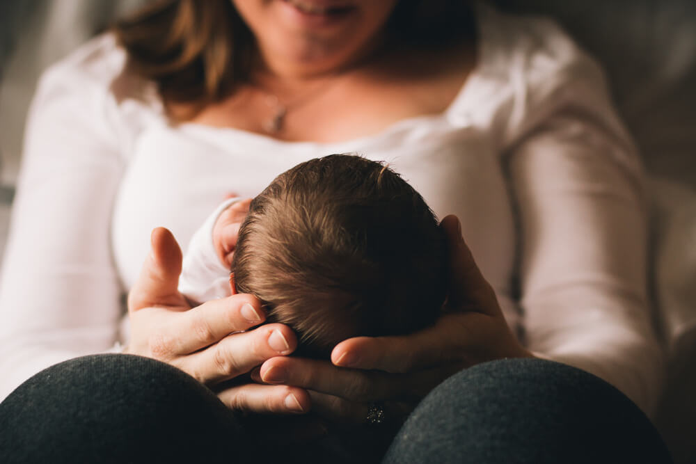 New mom holding newborn baby in her arms