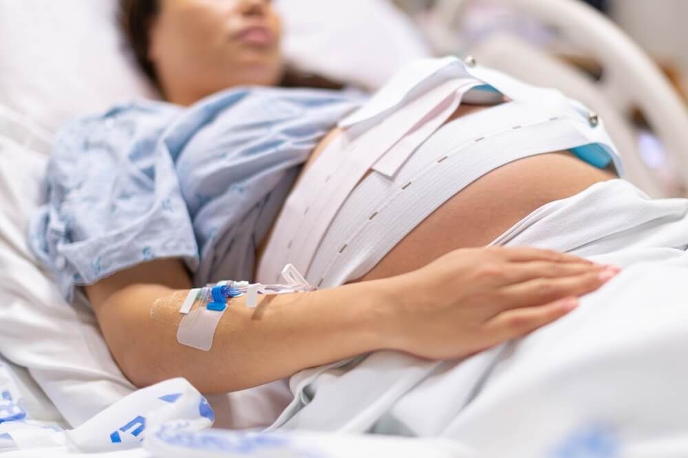 A pregnant woman in the hospital delivery room