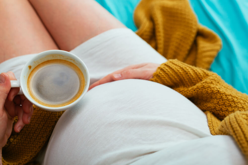 Pregnant woman drinking coffee